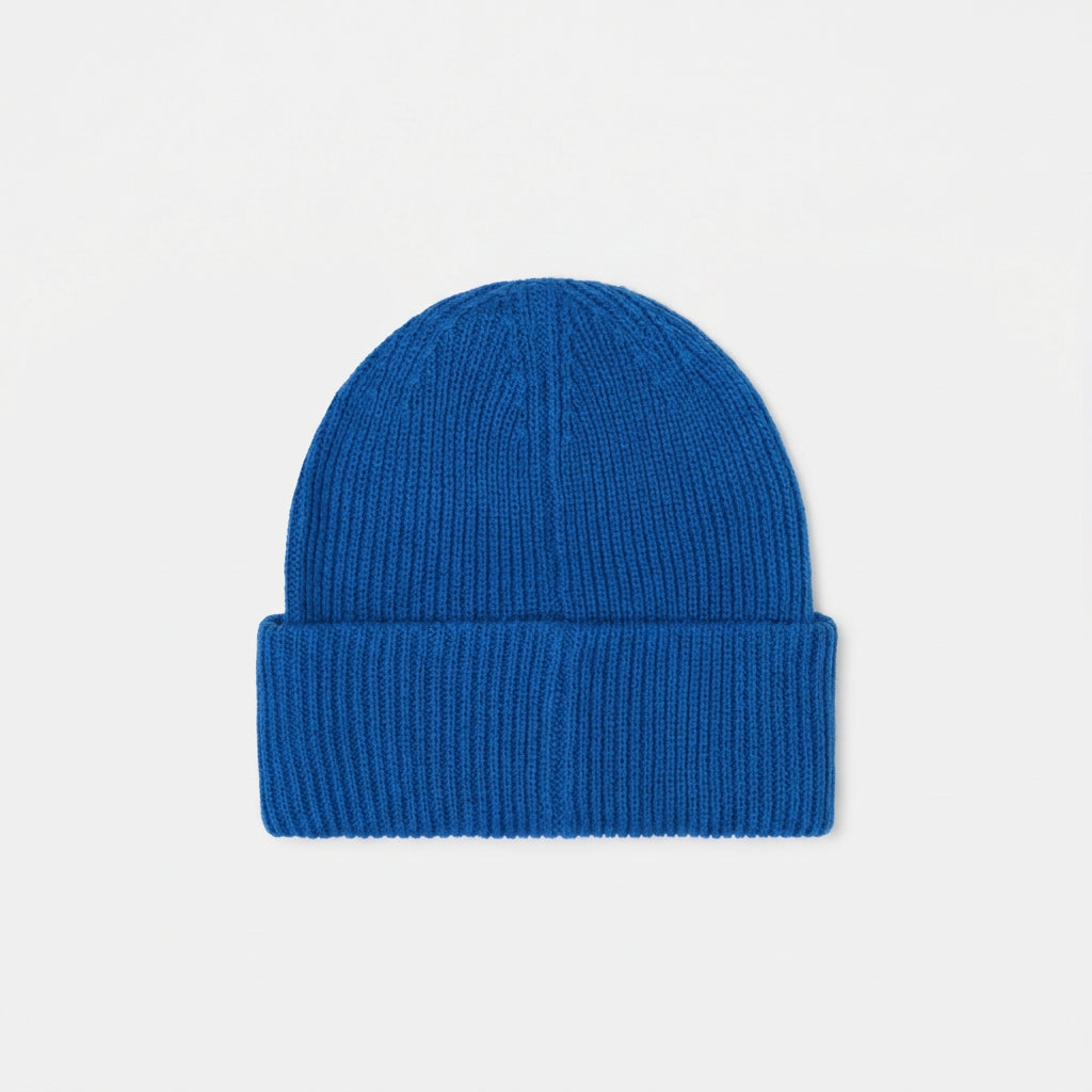 A bright blue ribbed knit beanie hat with a folded cuff, centered on a plain white background.
