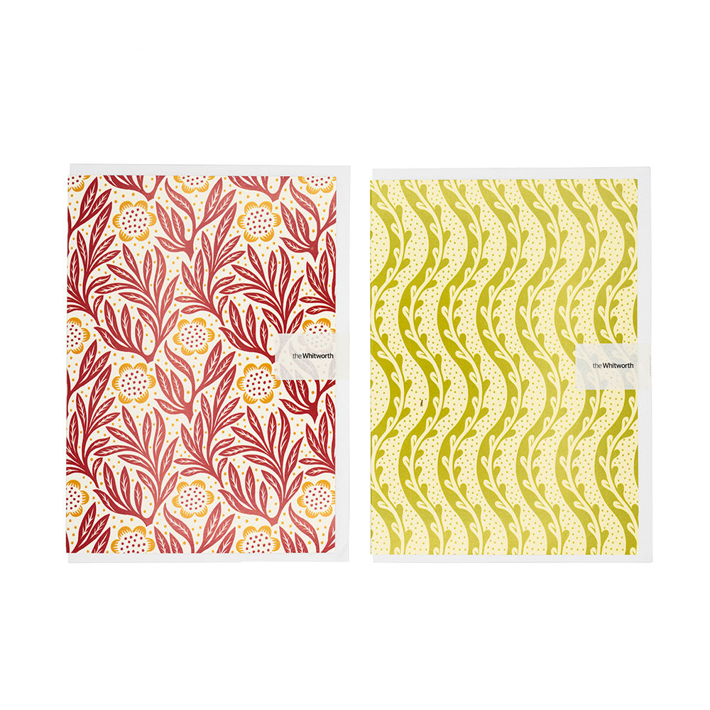 Two patterned greetings cards with floral and wavy designs on a white background