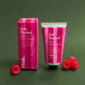 Hand cream and its packaging against green backdrop