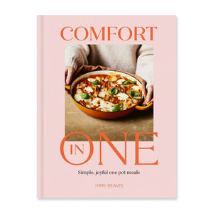Cookbook cover with person holding a pot with food inside