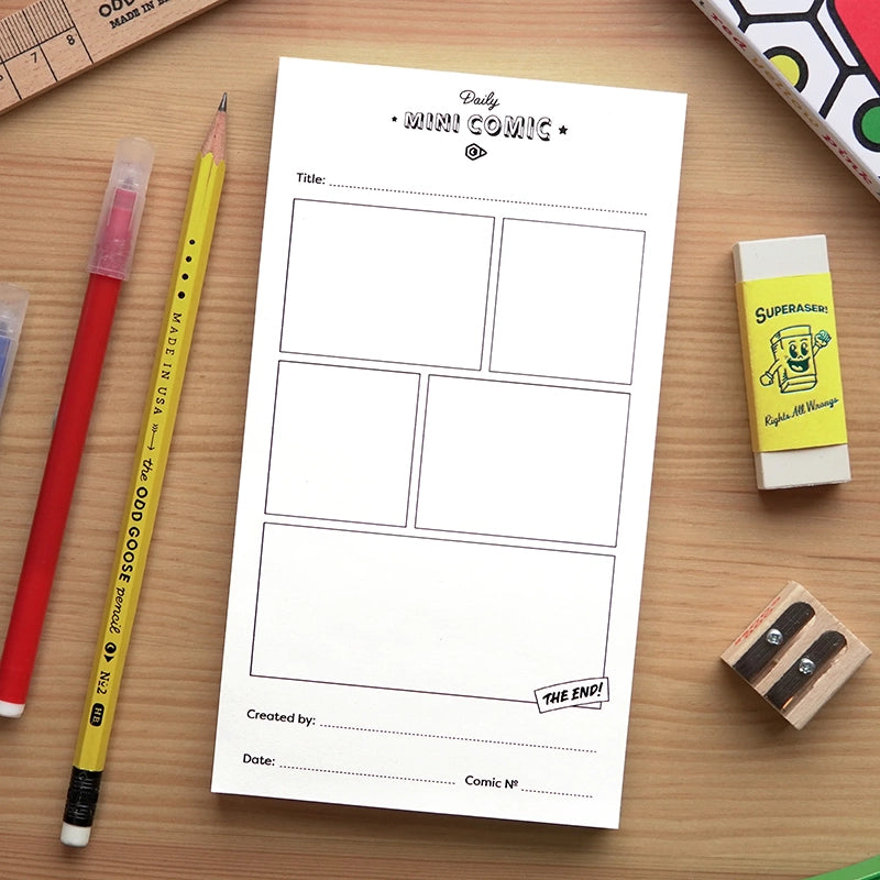 Comic book layout sheet with stationery items on a wooden surface