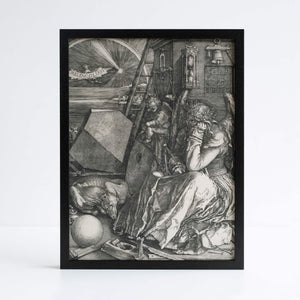 Albrecht Durer's Melencholia etching, featuring a figure sitting down. Photographed in black frame against white background