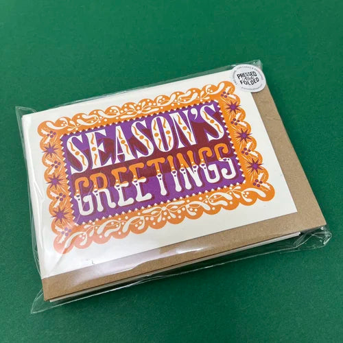 Packaged card with 'Season's Greetings' text on a green background