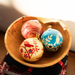 3 Baubles placed inside a wooden bowl