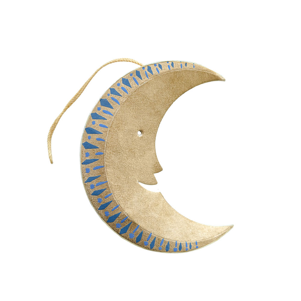 Decorative moon-shaped object with blue patterns on a white background