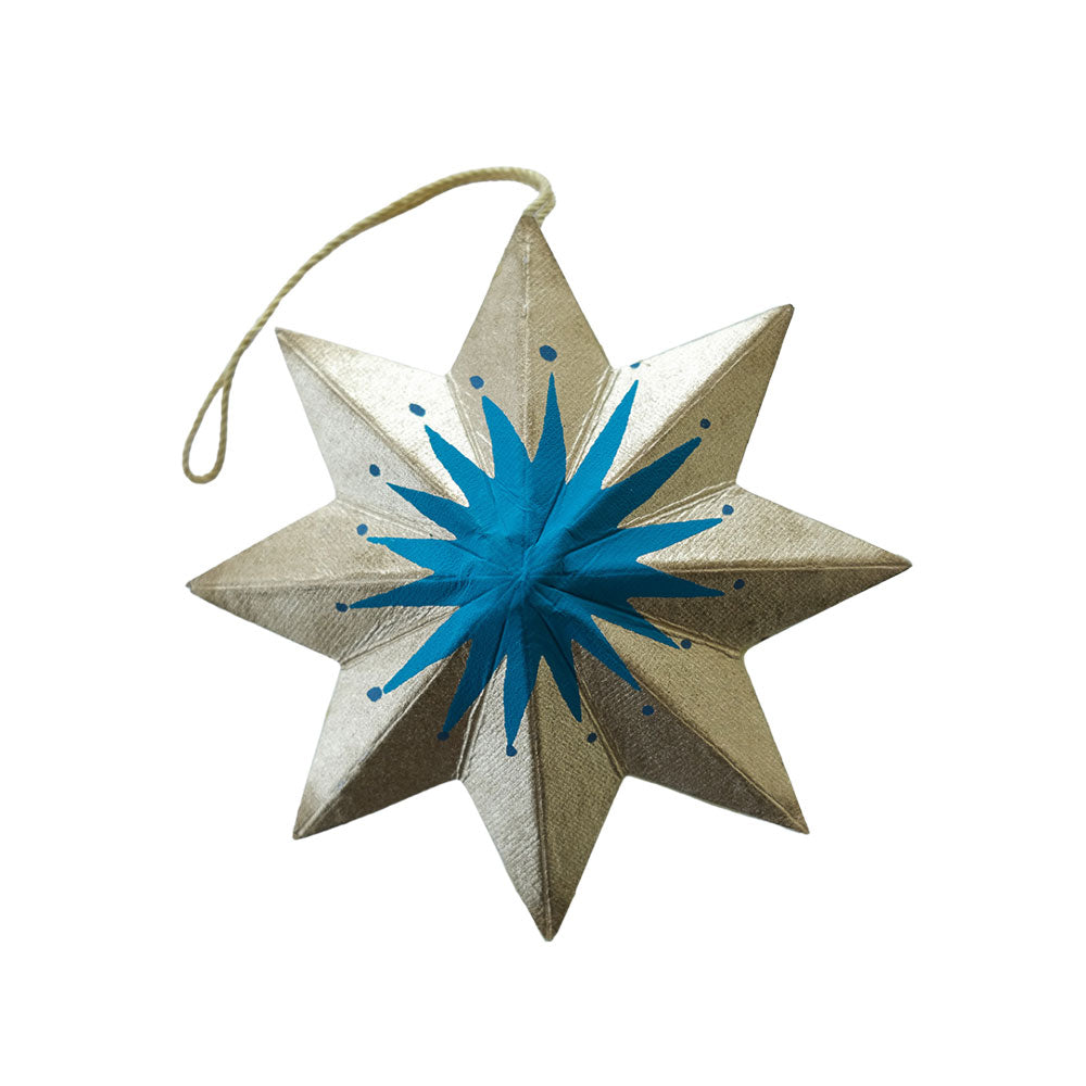 Decorative star ornament with blue center and gold edges on a white background