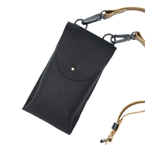 Image of rectangular navy back with brown handle against a white backdrop.