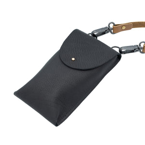 Image of rectangular navy back with brown handle against a white backdrop.