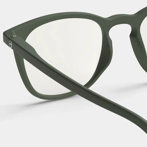 Close up of green reading glasses against a white background.