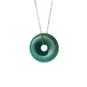 Circular pendant in teal colour with gold chain.
