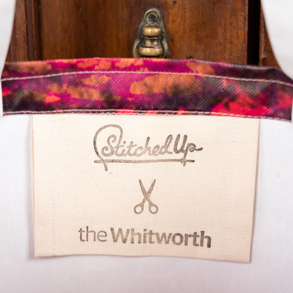 Inside label of a bag with Stitched Up and the Whitworth logo