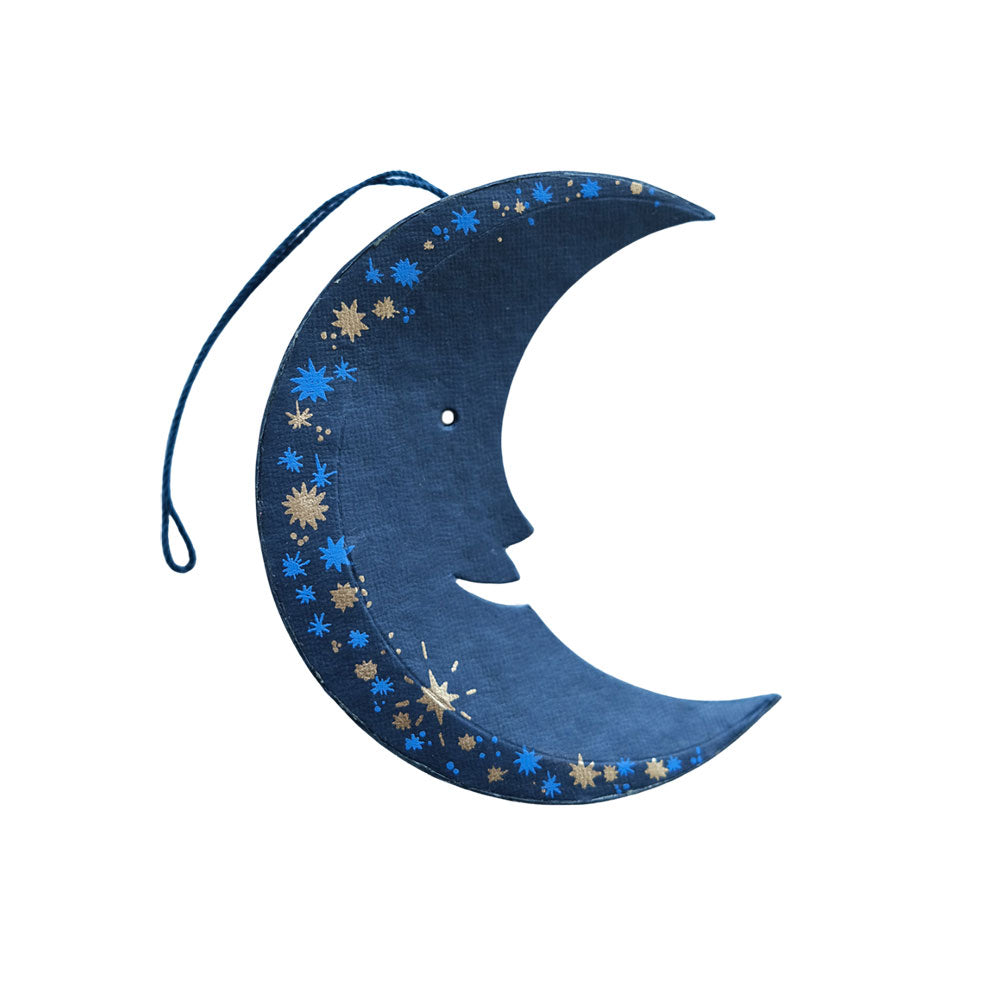 Decorative moon-shaped item with star patterns on a white background