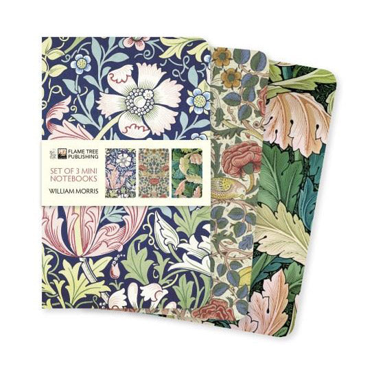 A set of three small notebooks with floral patterns by William Morris on the covers.