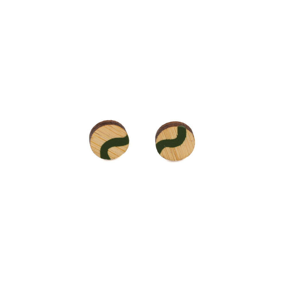 Circular shaped earrings against white background. Made out of wood and hand-painted with green swirls
