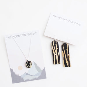 Wooden pendant necklace and matching earrings with branch-like pattern, presented on The Mountain and Me backing card