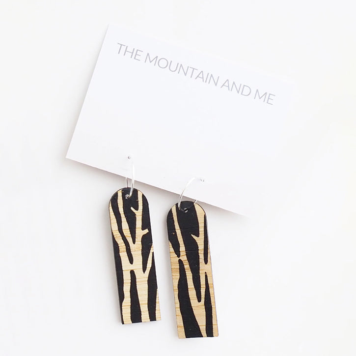 Dangly earrings against a white backdrop 
