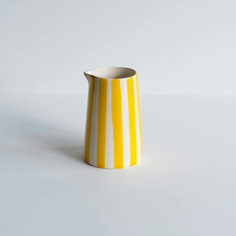 Ceramic creamer jug with a yellow candy stripe painted coat
