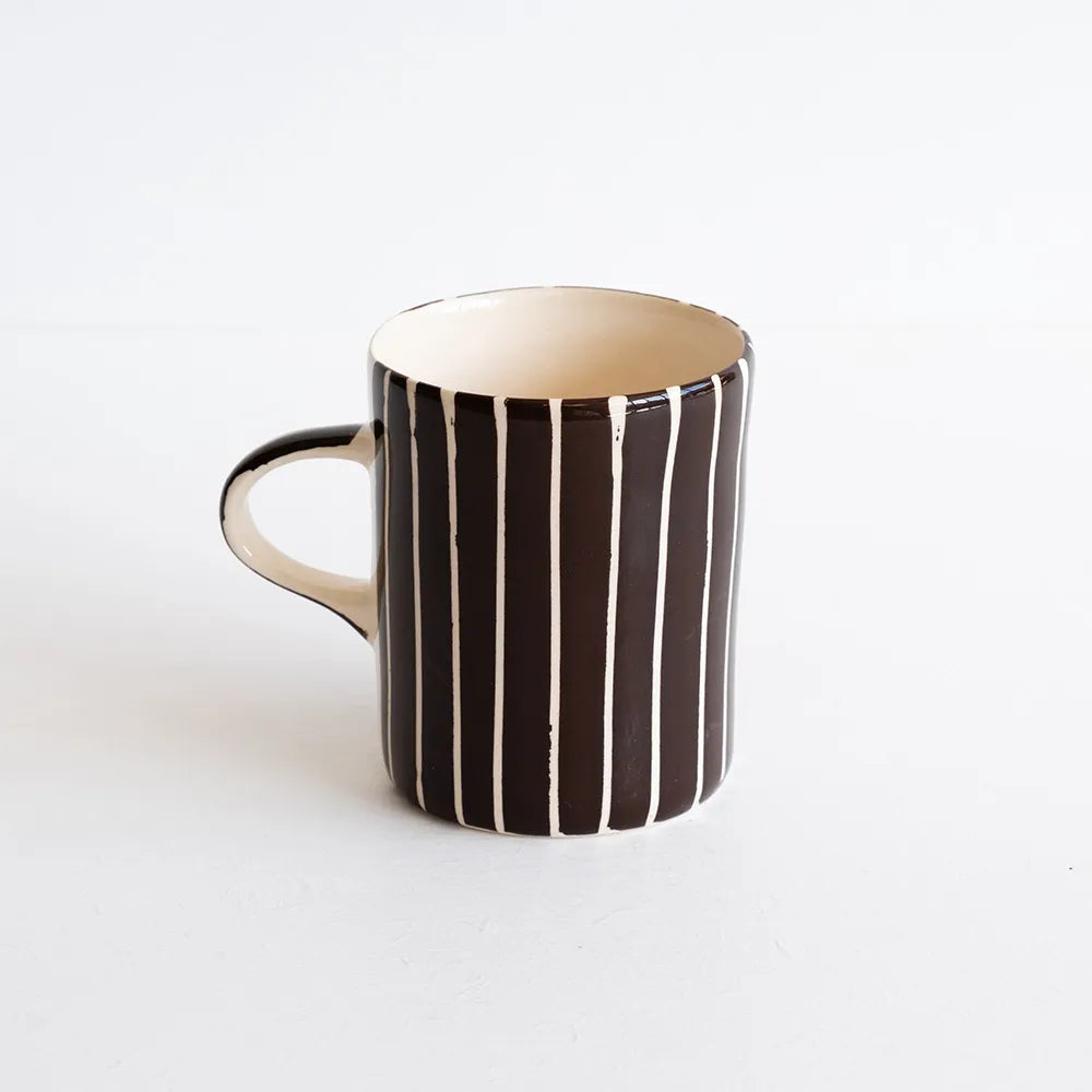 Brown and white striped mug against a white background.