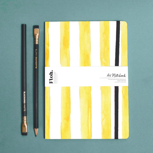 yellow striped notebook against blue backdrop