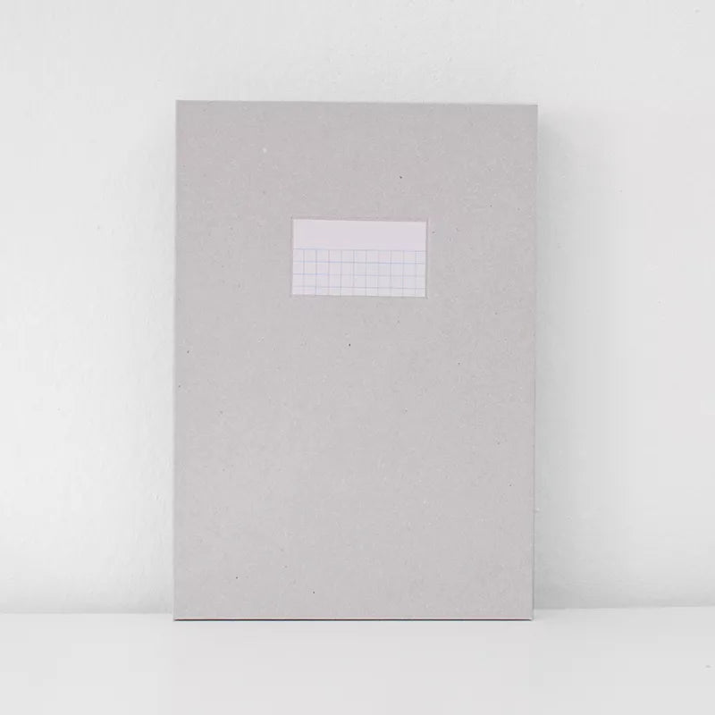 Gray notebook with a grid insert on a white background