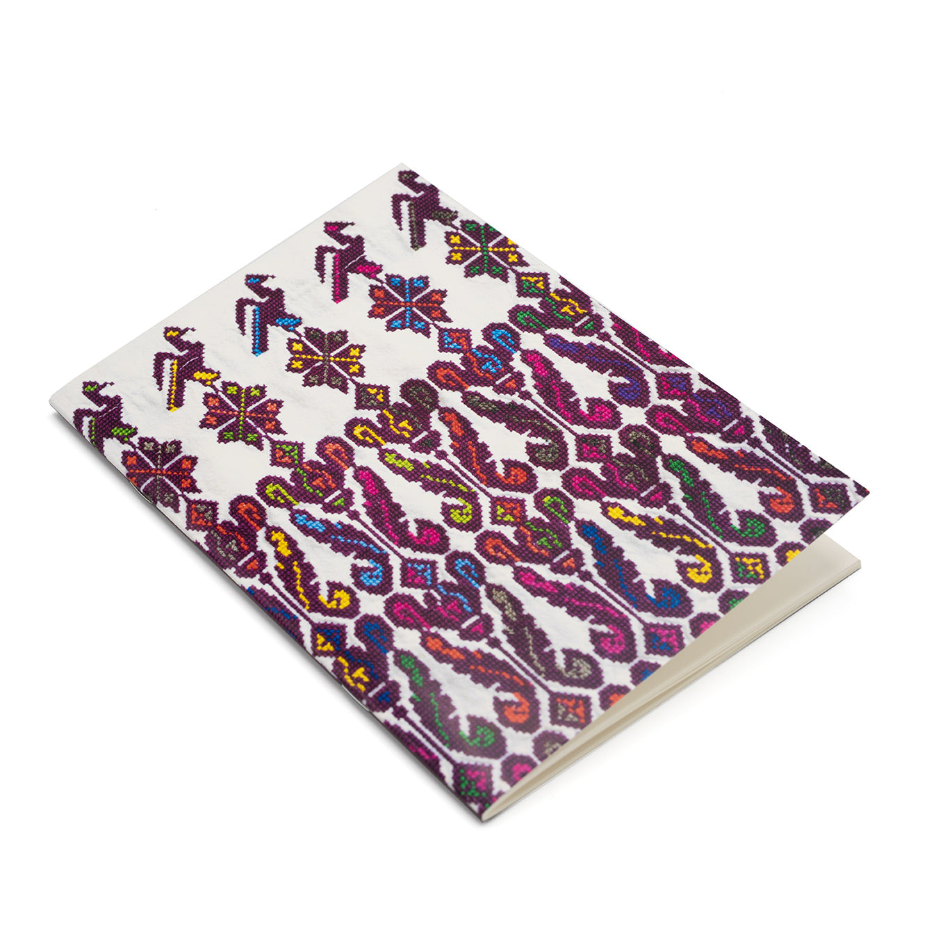 Notebook featuring a photographic detail of a purple, yellow and blue embroidered dress. The notebook is photographed against a white background.