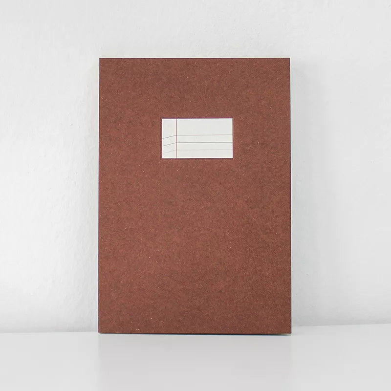 Brown notebook with a white label on a white background