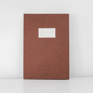 Brown notebook with a white label on a white background