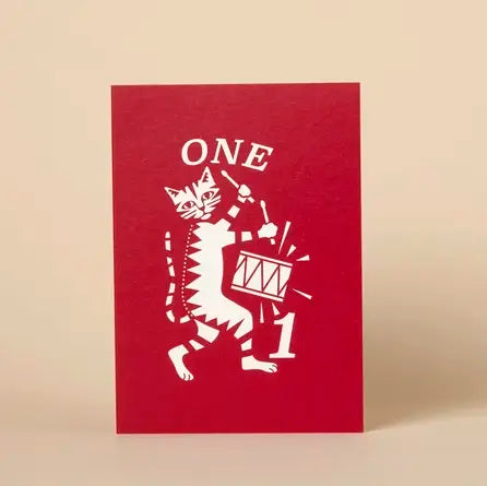 Red card with white cat design and 'ONE' text on a beige background