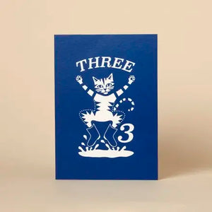 Blue card with white graphic of a cat and number '3' on a beige background