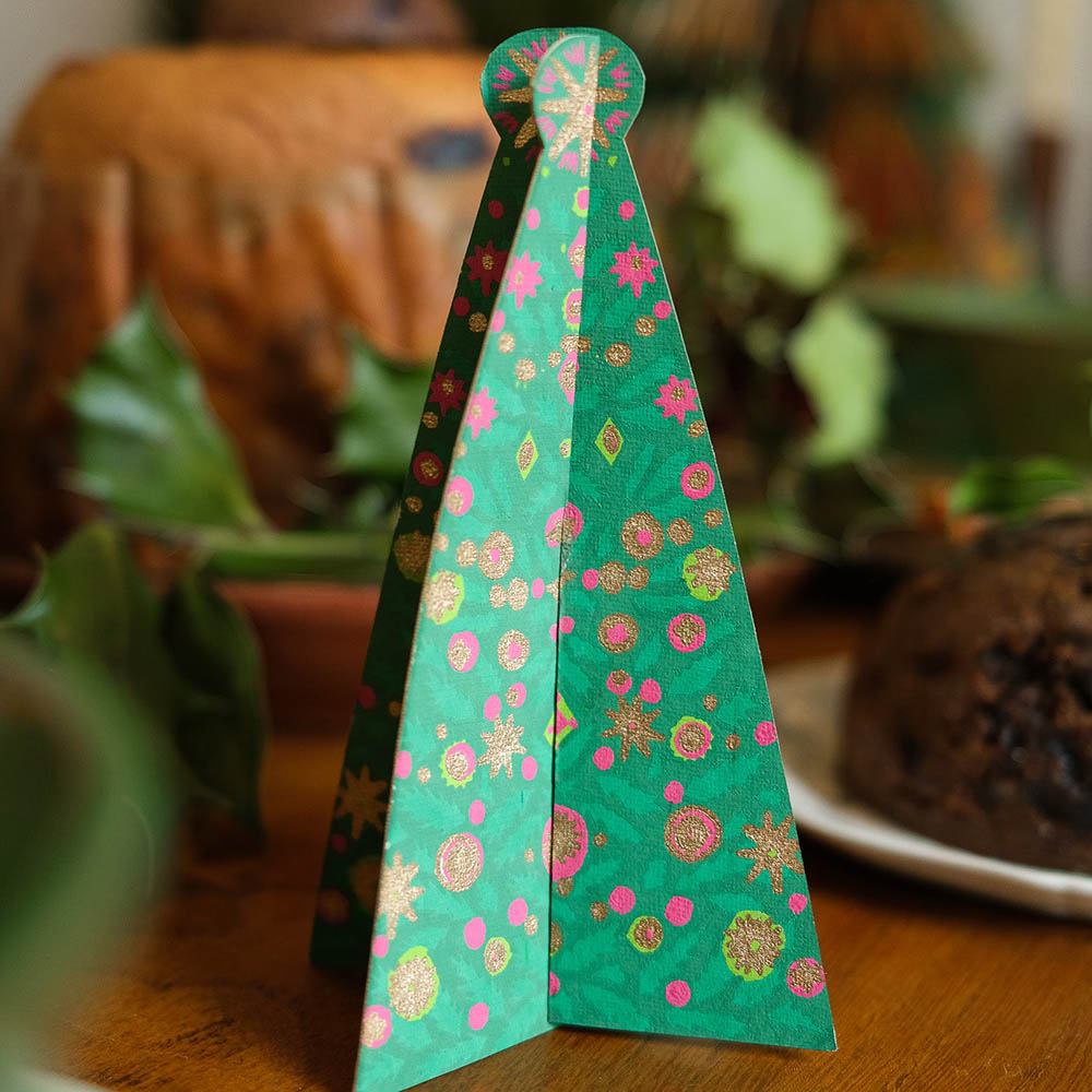 Tree shaped card ornament on a Christmas table