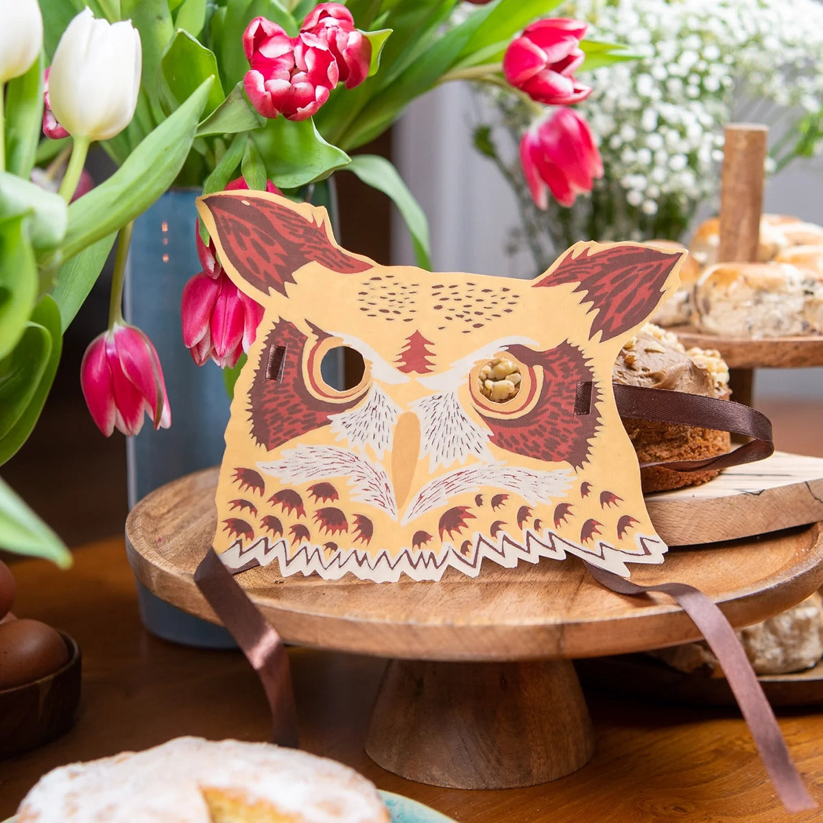 Owl shaped greetings card on a table surrounded by flowers