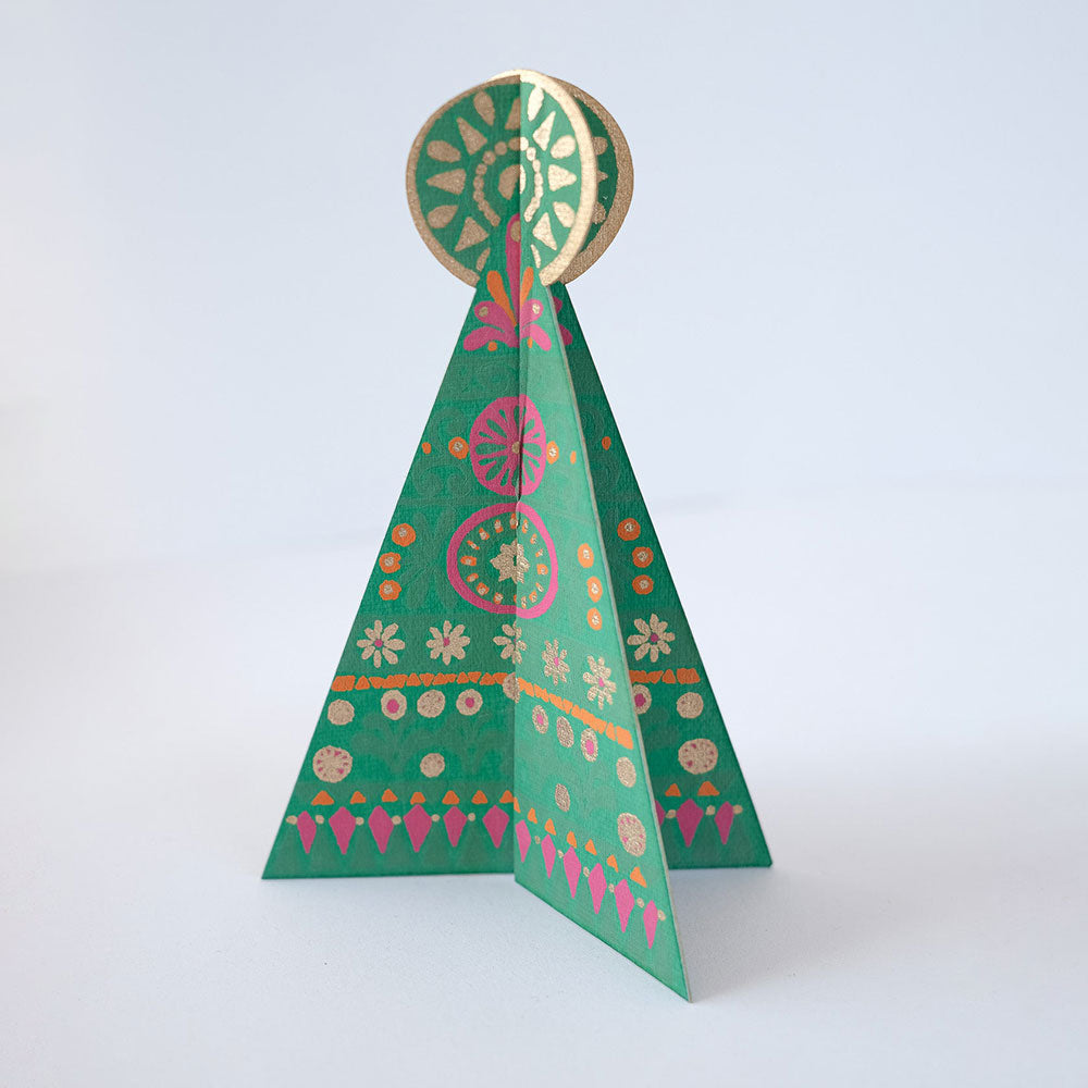 Tree greeting card ornament against a white backdrop