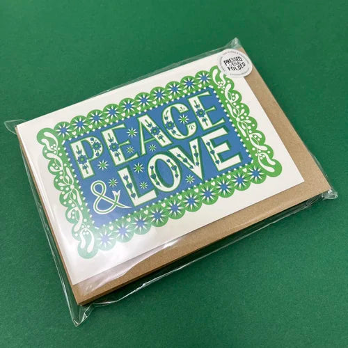 Packaged card with 'Peace & Love' text on a green background