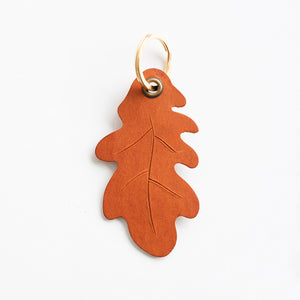 Brown leaf-shaped keyring on a white background