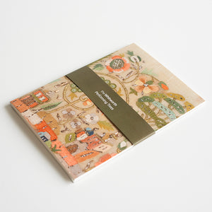 Notebook featuring an embroidered design on a white background.