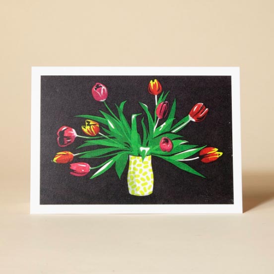A greetings card featuring a still life painting of a tulip 