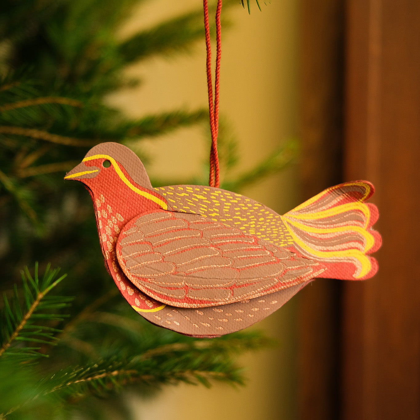 Decorative bird ornament hanging on a tree branch