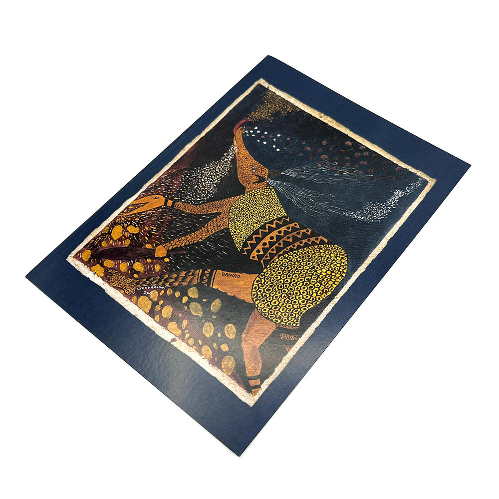 Navy notebook with a painting by Santiago Yahuarcani of a creature at the centre