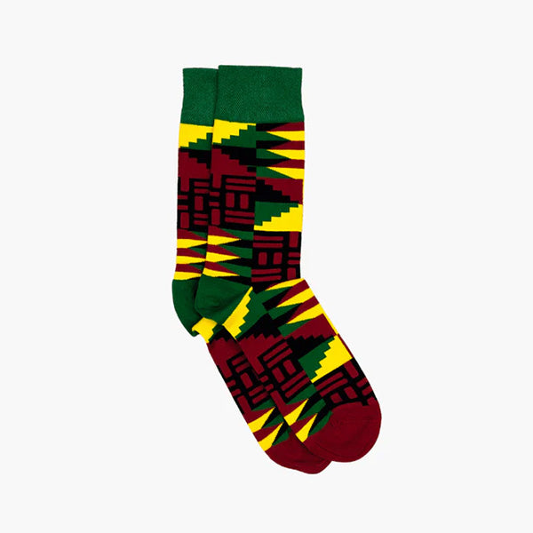 Socks against white background. Yellow, green and dark red pattern inspired by the Adinkra symbol 