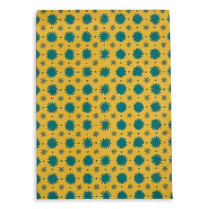 Yellow scrapbook cover with green star pattern against white backdrop.