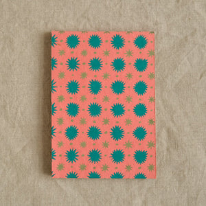 Front cover of a peach scrapbook with green star pattern