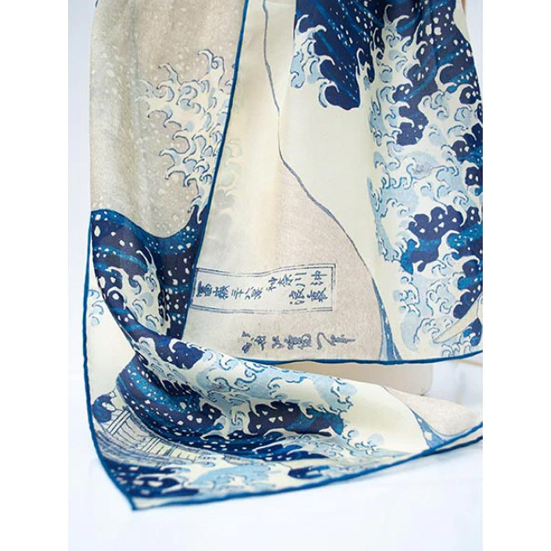 Silk scarf with blue wave design and text on a white background