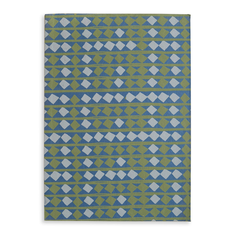 Blue sketchbook with screen-printed blue and green repeat pattern of diamonds.