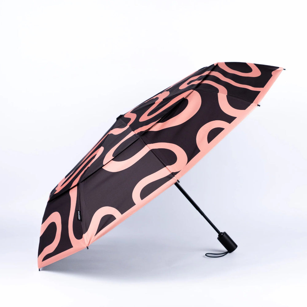 Black umbrella with pink wavy pattern on a white background