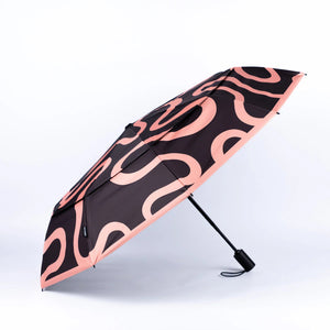 Black umbrella with pink wavy pattern on a white background
