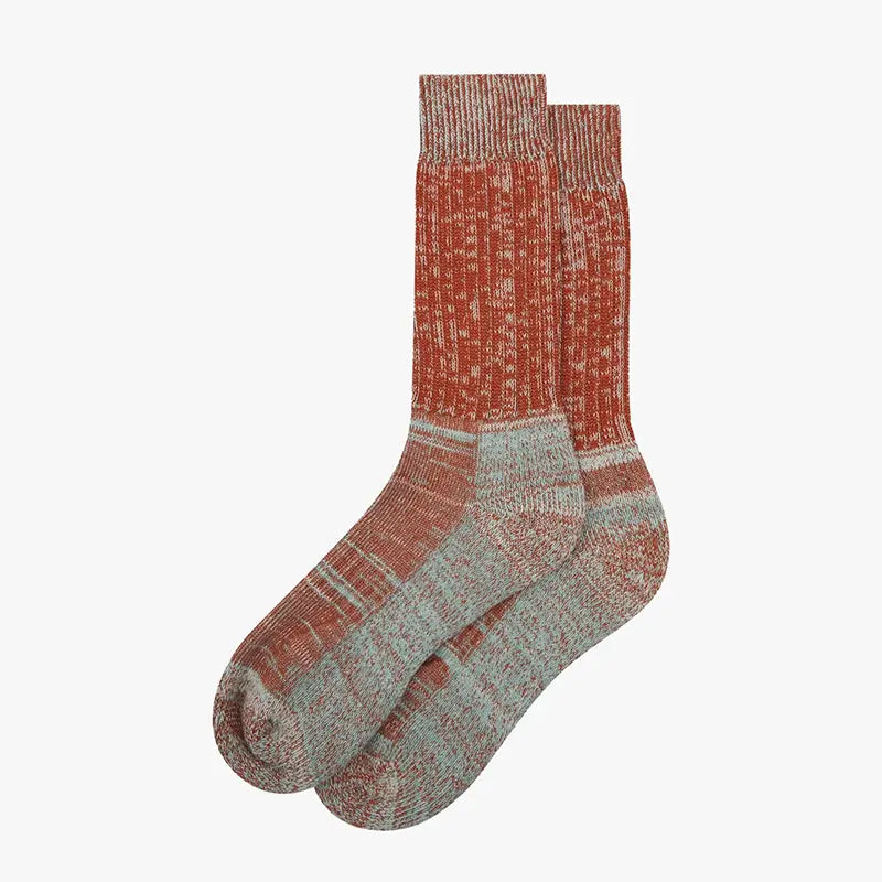 Pair of rust and blue cotton socks against a white background