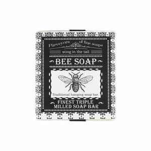 Black and white square packaging for soap. Featuring illustration of bee and decorative border.