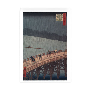 Greetings card and white envelope featuring Japanese woodcut print of people walking across a bridge in the rain.