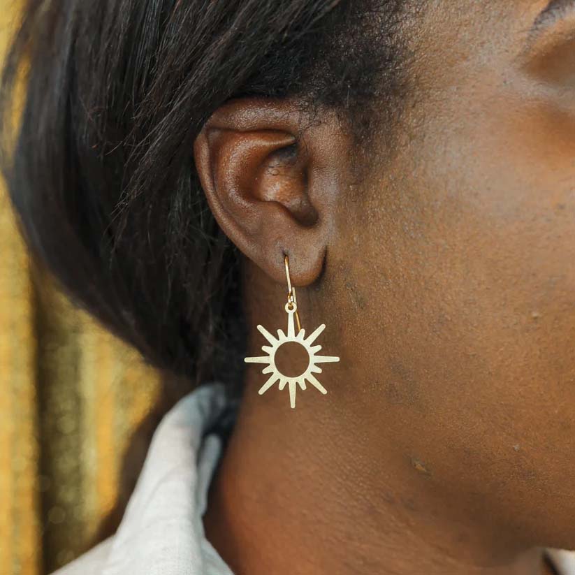 A close up of a person wearing the earrings.