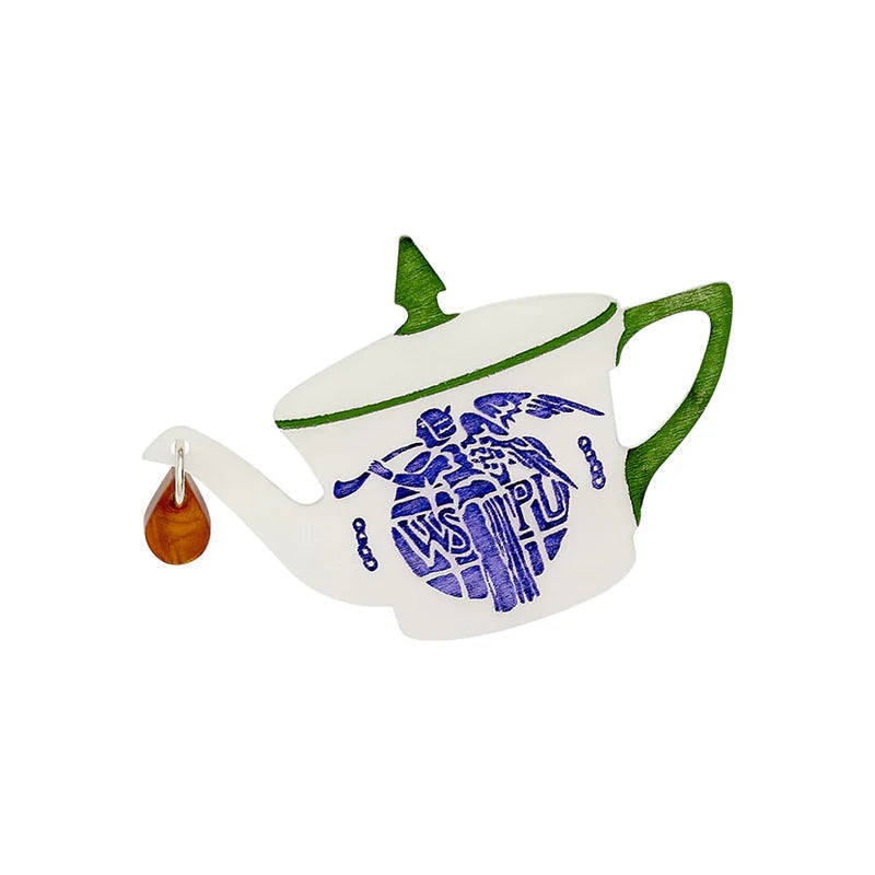 Teapot brooch with a blue design on a white background